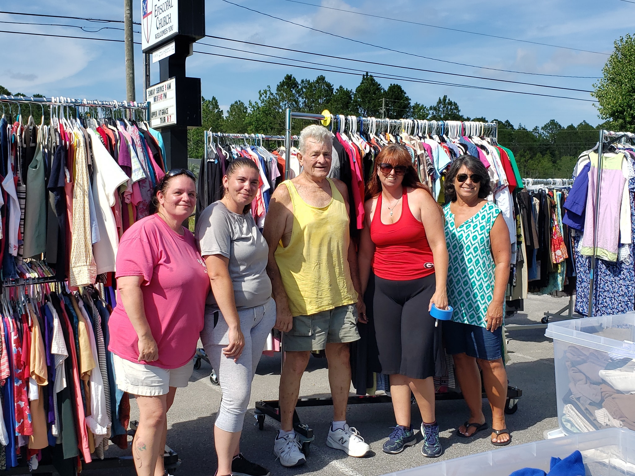 Group shopping at outdoor clothing sale