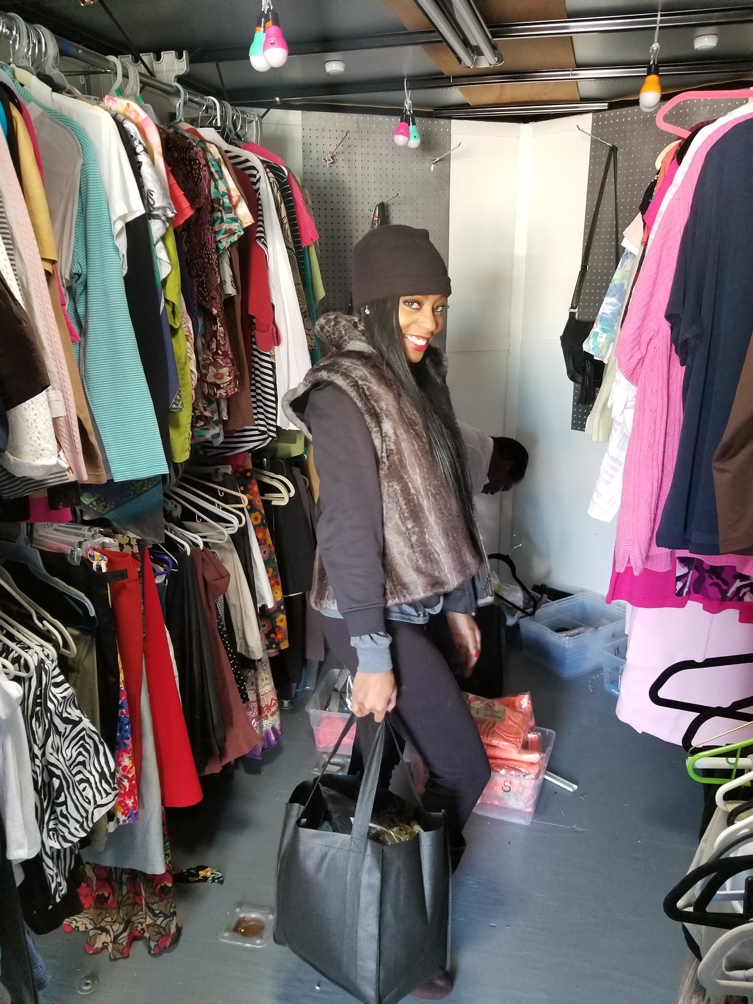 Woman shopping in crowded clothing closet