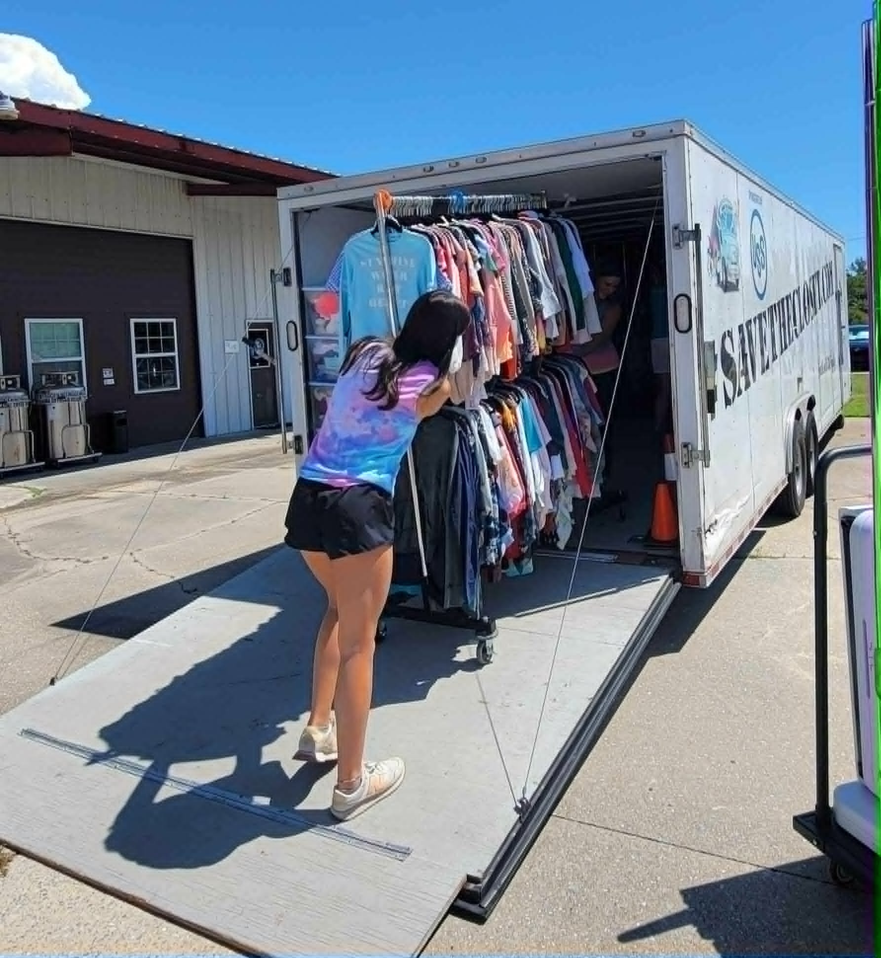 Woman shopping at mobile clothing truck