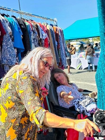 Women shopping vintage clothing outdoor market