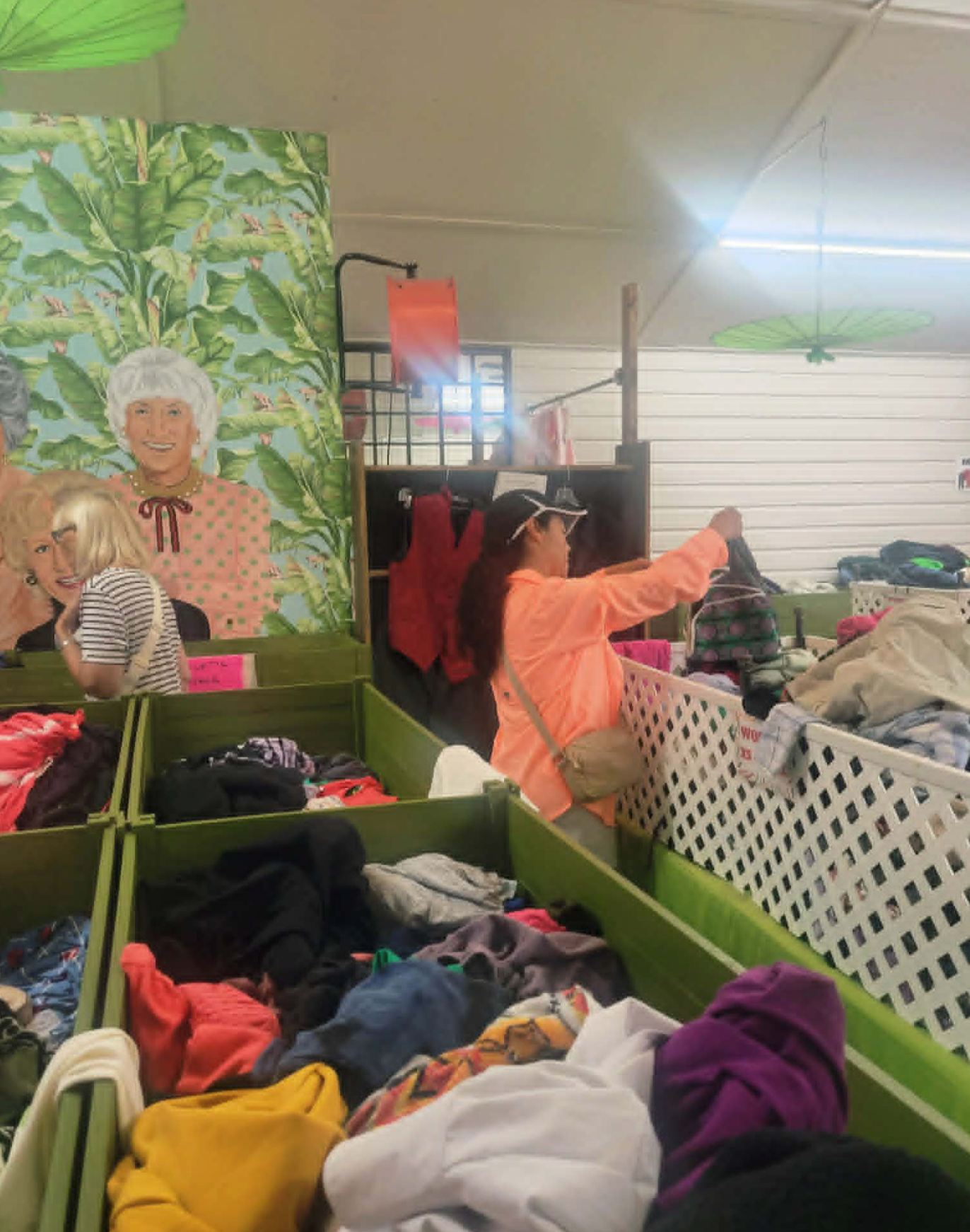 Shoppers digging through clothing bins at the Bargain Attic